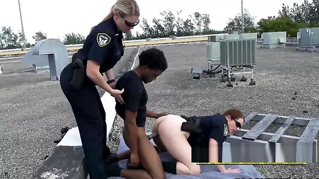Fro dude is arrested and fucked on rooftop by perverted female officers