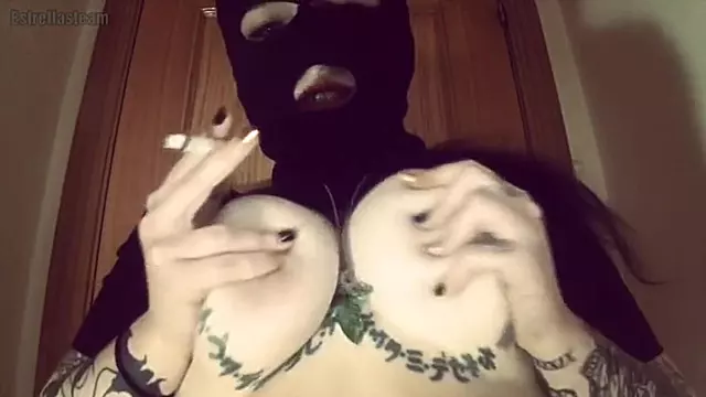 Girl With A Mask Plays With Her Tits And Smokes A Cigarette