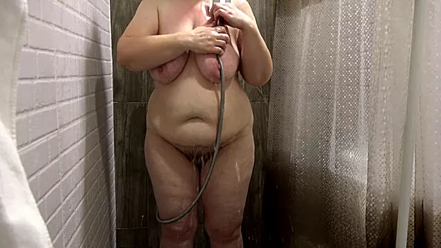 Spying on a voluptuous mature woman in the shower. Mature big beautiful woman cleans her juicy booty, large breasts, and bushy vagina. Amateur voyeurism. Plus-size.